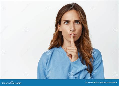 Portrait Of Angry Brunette Woman Hushing Frowning Upset And Shushing