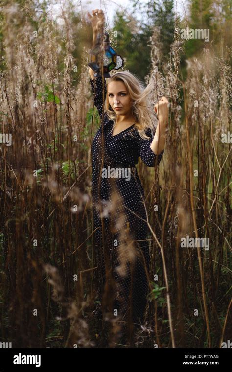 Blonde In The Forest In The Hands Of A Girl Holding A Vintage Lantern Stock Photo Alamy