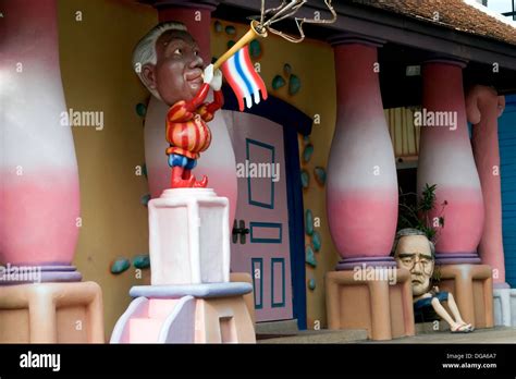 A Plastic Sculpture Of A Cartoonish Looking Man Playing A Bugle Is On