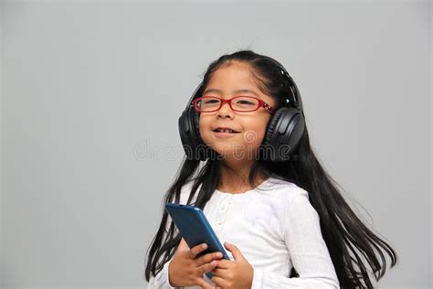 Year Old Brunette Latin Girl With Glasses Listens To Music In Her Headphones Connected To Her