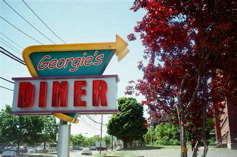 A Large Neon Sign Advertising A Diner Photo Free Shot On Film Image