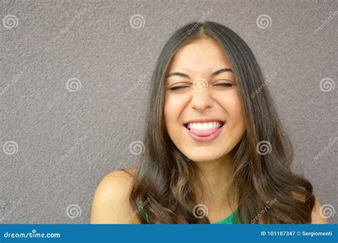 Beautiful Brunette Girl Closes Her Eyes And Shows Tongue On Isolate Copyspace Violet Stock Image