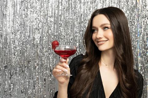 Premium Photo Attractive Brunette At A Party With A Cocktail In Her Hand