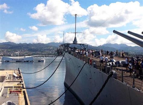 At Pearl Harbor, the bow of the Battleship Missouri Memorial points toward the Arizona Memorial ...