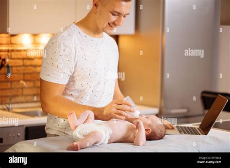Dad Trying To Work While Standing With His Newborn Babe In Home Office Interior Stock Photo Alamy