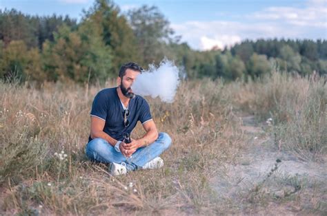 Premium Photo Brutal Vape Man Smoking An Electronic Cigarette In The