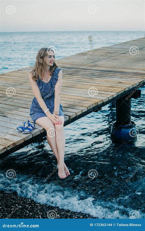 Romantic Traveler Woman In A Blue Dress Is Enjoying A Beach Holiday A