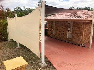 A Brick Building With A White Awning Next To It