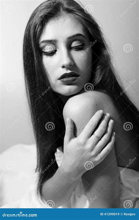 Portrait Of Seductive Woman Touching Her Naked Shoulder Looking Down