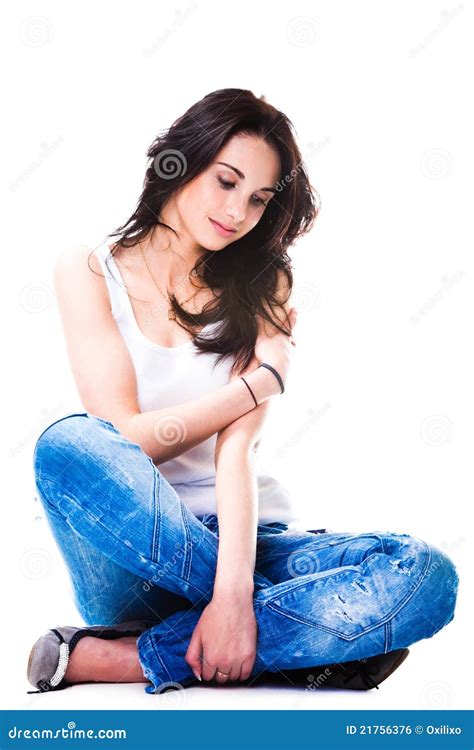 Pretty Woman In Blue Jeans Sitting On White Floor Stock Photo Image