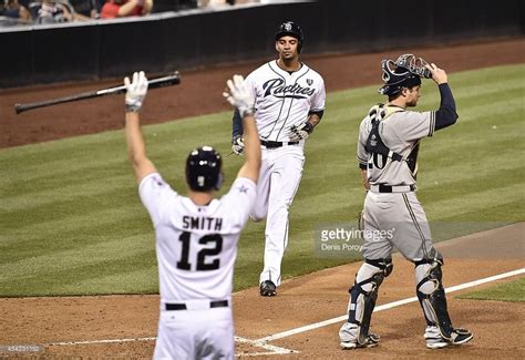 Seth Smith of the San Diego Padres signals not to slide as Tyson Ross ...