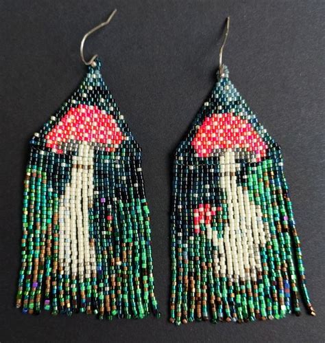 Two Pairs Of Beaded Earrings With An Image Of A Woman On The Front And Back