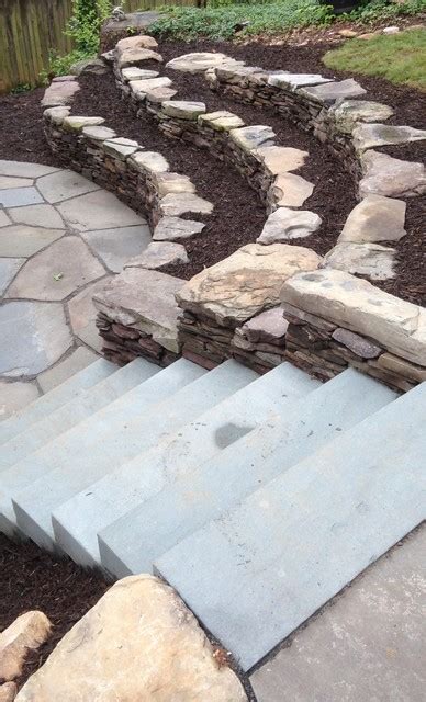 Backyard Patio And Natural Stone Retaining Walls With Stairs