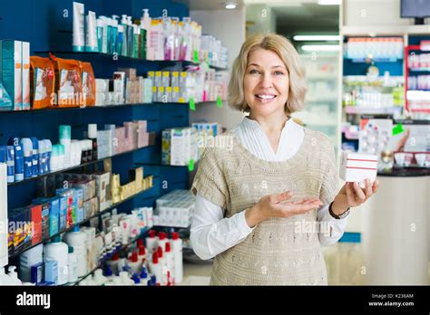 Mature Blonde Woman Near Counter In Pharmacy Drugstore Stock Photo Alamy