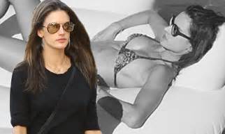 Alessandra Ambrosio Soaks Up The Sun In A Skimpy Bikini Before Flashing Her Midriff At The