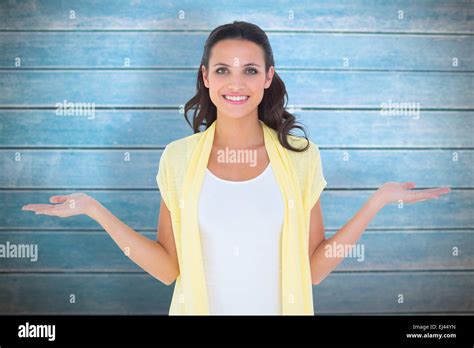 Composite Image Of Pretty Brunette Presenting With Hands Stock Photo
