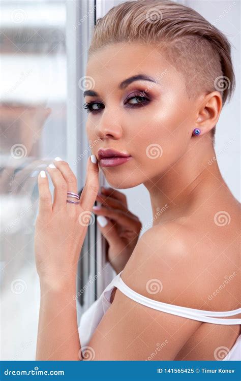 Closeup Portrait Blonde Model With Bright Make Up And Short Hair With Shaved Temples In Modern