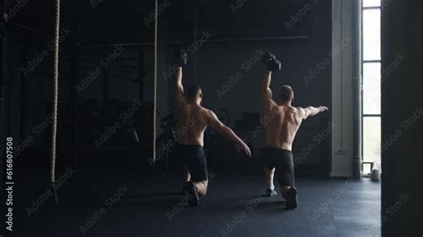 Pair Of Sportsmen With Naked Muscular Torso Doing Exercises In Gym