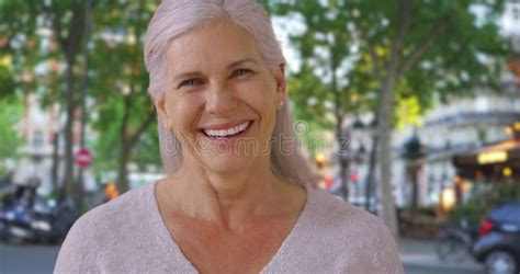 Lovely Mature Woman Standing Outside Beautiful Suburban Home Smiling At Camera Stock Video