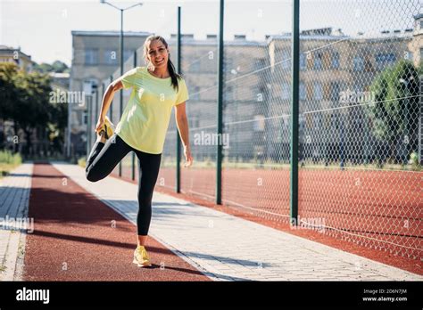 Beautiful Brunette Stretching Legs At Modern Stadium Stock Photo Alamy