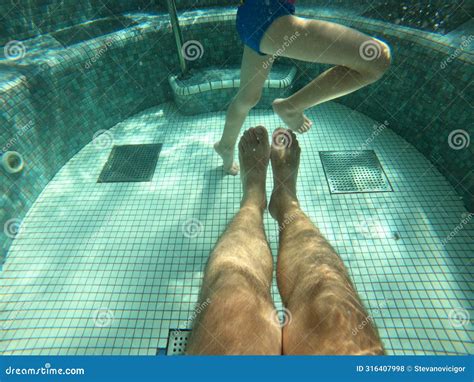 Hot Tub Pool Underwater Shot Of Father And Son Legs In Water Stock