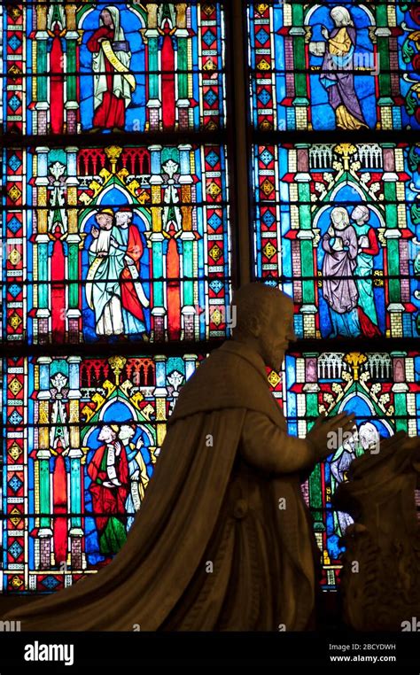 Statue And Stained Glass Windows Notre Dame Cathedral Paris France