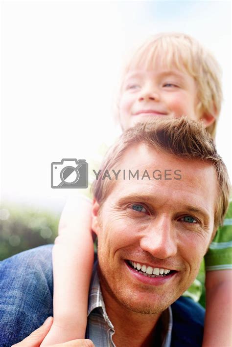 Smiling Mature Man Giving His Son Piggyback Ride Closeup Portrait Of A Smiling Mature Man