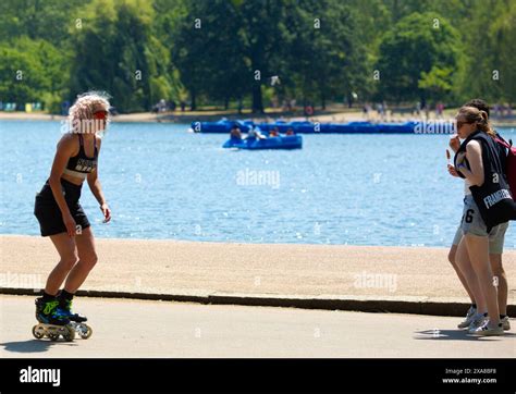 People Enjoy A Spell Of Hot Weather As Some Sunbathe And Others Avoid The Direct Sunshine In