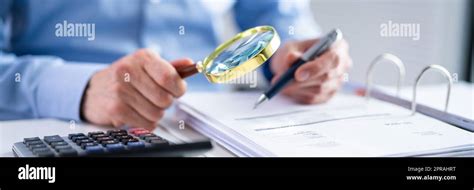 Business Fraud Investigation Using Magnifying Glass Stock Photo Alamy
