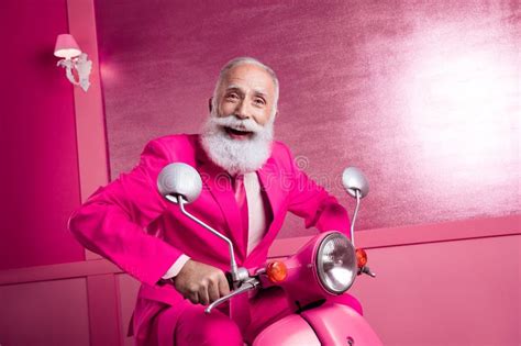 Photo Of Excited Mature Old Man Drive Motor Bike Fast Speed In Home Pink Color Interior Stock