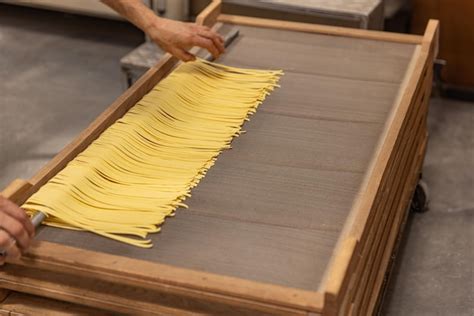 Premium Photo Fresh Pasta Drying On Wooden Rack