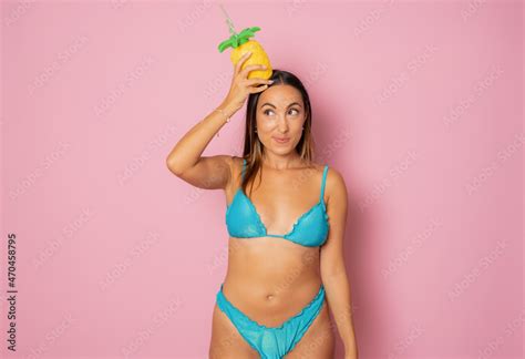 Beautiful Funny Woman In Bikini Holding Juice Isolated Over Pink Background Stock Photo Adobe