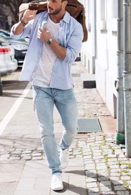 Picture Of white sneakers, blue jeans, a white tee and a blue shirt