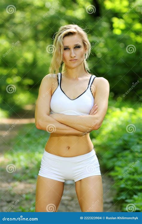 The Blonde In Red Form With A Ball At The Gate On The Football Field Royalty Free Stock