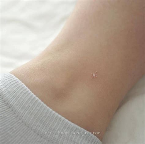 A Small Star Tattoo On The Side Of A Woman S Ankle With Tiny Stars