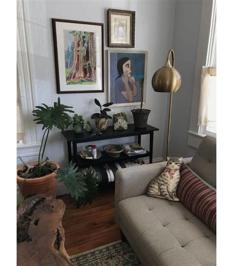 A Living Room Filled With Furniture And Pictures On The Wall Next To A