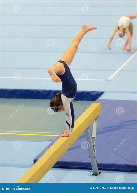 Young Gymnast Girl Performing Routine On Balance Beam Stock Photo ...