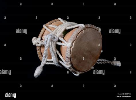 Damaru Drum. Close-up. Black background Stock Photo - Alamy
