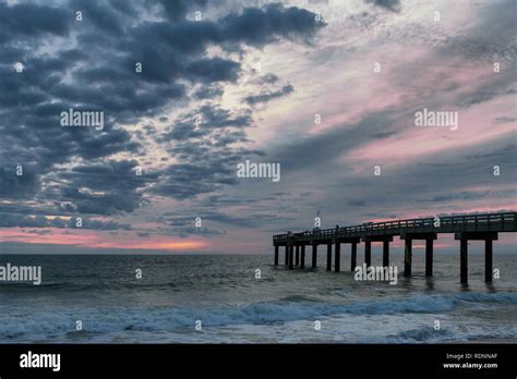 Sunrise at the St. Augustine Beach Pier, or St. Johns County Ocean Pier, in St. Augustine ...