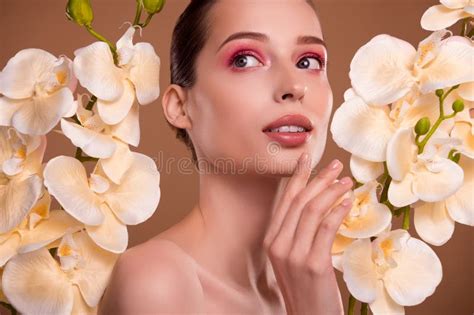 Photo Of Dreamy Seductive Woman Naked Shoulders Enjoying Orchid Extract Brown Color Background