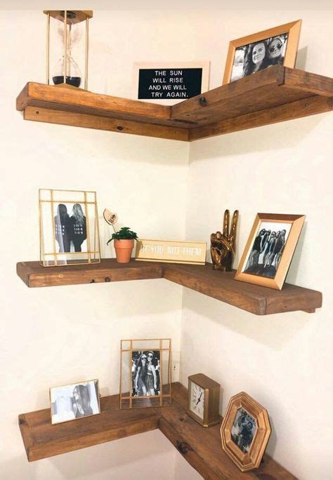 Three Wooden Shelves With Pictures And Frames On Them