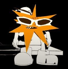 an orange and white star sitting on top of a table next to a laptop computer