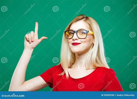 Cute Blonde Is Showing Up By Finger And Smiling On Green Background Portrait Of Beautiful Girl