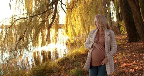 Happy Pregnant Blonde Walks In The Park Along The Pond Stock Video Video Of Park Look