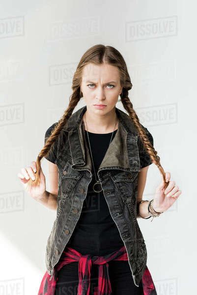 Portrait Of Attractive Blonde Rocker Girl With Braids Posing And Looking At Camera Isolated On