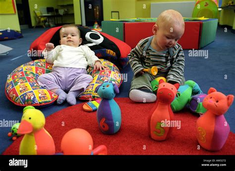 Young Children And Toddlers Playing On Soft Play Area Stock Photo