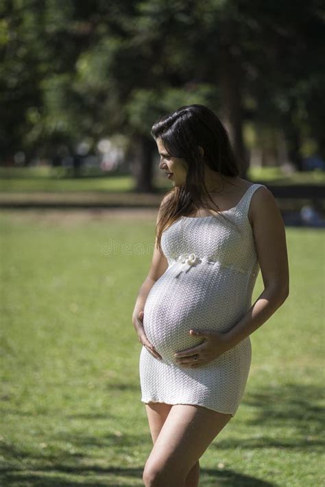 Portrait Of Pregnant Latina Woman In A Park Stock Image Image Of Belly Lying