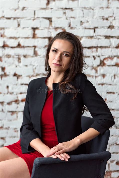 Middle Aged Brunette Woman Sitting On Bed In The Evening Stock Image