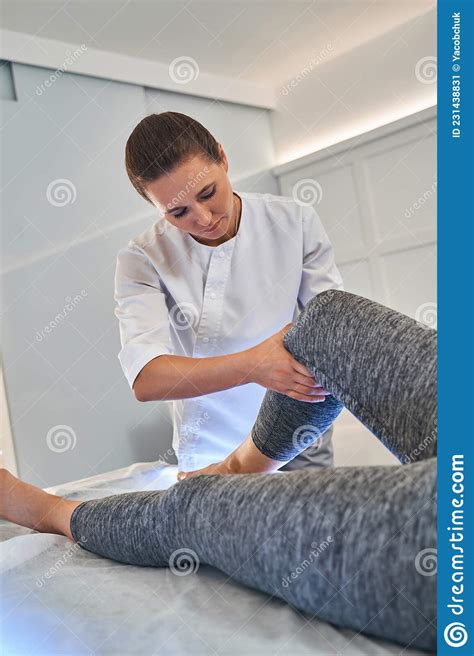 Serious Female Therapist Doing Treating Massage For Client Stock Image