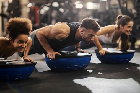 Premium Photo Sportspeople Doing Workouts With Bosu Ball In A Gym